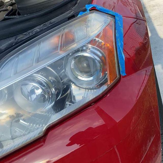 Restored headlight on a red car